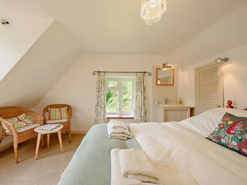 a bedroom with a bed and a chair and a window at 2 Bed in Llandovery oc-bn094 in Llandovery