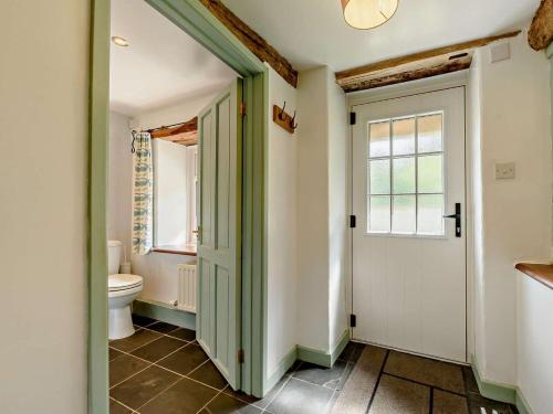a bathroom with a toilet and a window and a door at 2 Bed in Llandovery oc-bn094 in Llandovery