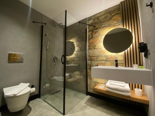 a bathroom with a shower and a sink and a toilet at Asterina Hotel in Turgutreis