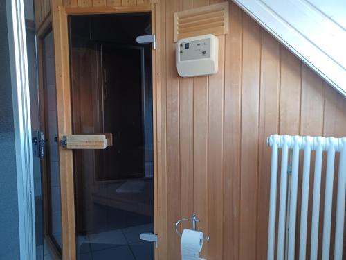 a door to a bathroom with a heater in a room at Adler Gaststube Hotel Biergarten in Bad Rappenau