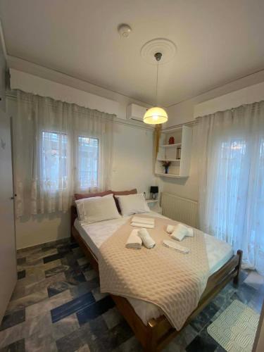 a bedroom with a bed with two towels on it at Maria,s house in Petra