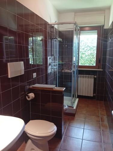 a bathroom with a toilet and a glass shower at Mimì Home in Isernia