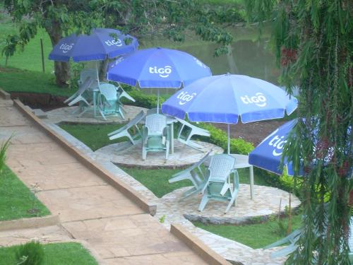 a group of blue tables and chairs with umbrellas at Kakakuona Resort in Lushoto