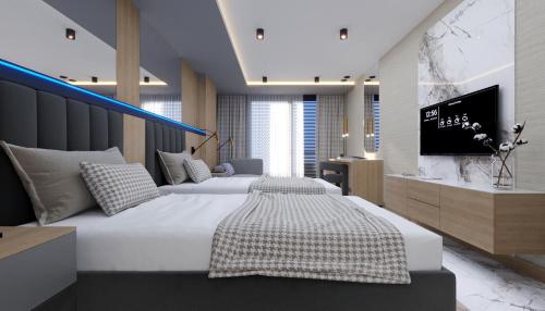 a bedroom with two beds and a flat screen tv at Almaris Resort Hotel - Ultra All Inclusive in Alanya