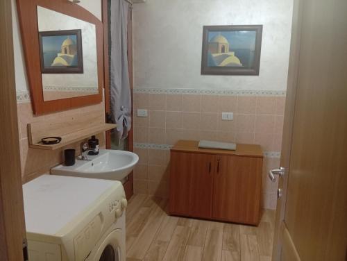 a bathroom with a sink and a washing machine at Lillo Home in Isernia