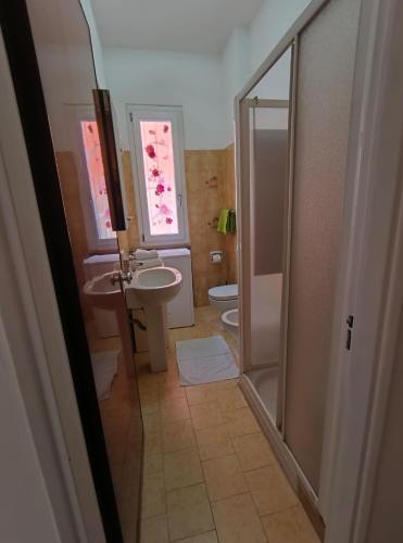 a bathroom with a shower and a sink and a toilet at A cà du Piero in Albisola Superiore
