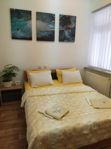 a bedroom with a bed with two towels on it at Міні Готель Особняк in Lviv