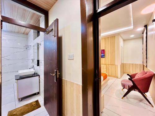 a door leading into a bathroom with a chair at The Pranav Retreat A Premium Property in Nainital