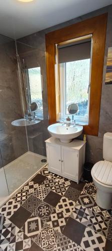 a bathroom with a sink and a shower and a toilet at Number 4, Loch Shiel View in Glenfinnan