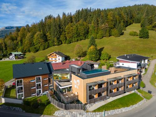 an aerial view of a building on a hill at Genuss- & Aktivhotel Sonnenburg in Riezlern