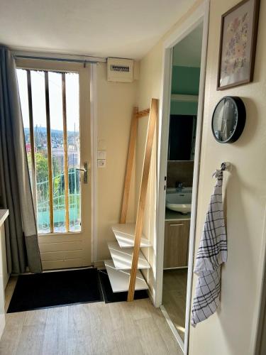 a room with a door open to a room with a balcony at Studio cosy 71 in Saint-Vallier