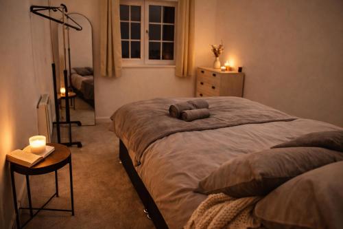 a bedroom with a bed with two pillows on it at Beautiful Modern Home in Wisbech with Private Garden in Wisbech Saint Mary