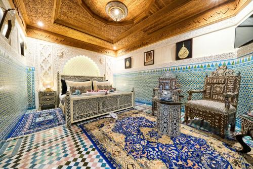 a bedroom with blue and white tiled walls and a ceiling at Riad May Fes Original & Spa in Fez