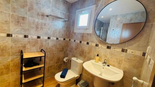 a bathroom with a sink and a toilet and a mirror at Casa Vista Mar Oliastur El Cotillo in El Cotillo