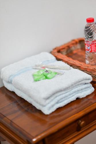 a pile of white towels on a wooden table at Kahyuna Hotel Bromo in Sukapura
