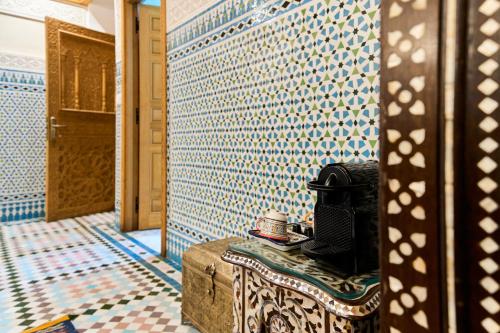 a room with a blue and white tiled wall at Riad May Fes Original & Spa in Fez