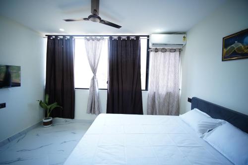a bedroom with a large bed and a window at sinhgad hills in Kharakvasla