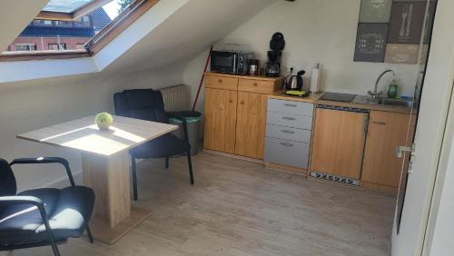 a kitchen with a table and chairs in a room at Studio Apartment in Alsdorf