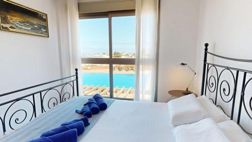 a bedroom with a bed with a view of a pool at Beach Apartment Marfolin 06 El Cotillo in El Cotillo