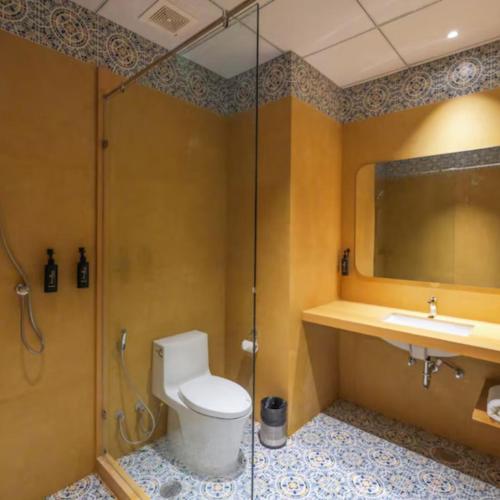 a bathroom with a toilet and a shower and a sink at The Forresta Checks-In, Jaipur in Jaipur