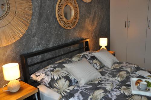 a bed in a room with two lamps on it at Apartament SANOVA 55 in Sanok