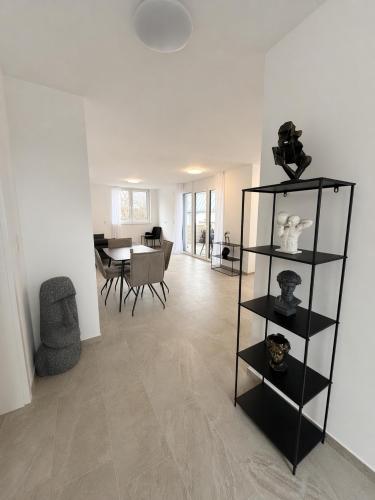 a living room with a black shelf with vases on it at Apartments Nilada in Zirl