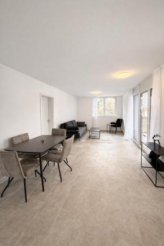 a large living room with a table and chairs at Apartments Nilada in Zirl
