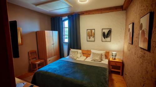 a small bedroom with a bed and a window at Penzion Mlýn Sedlec in Sedlec