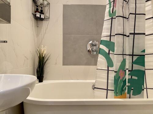a bathroom with a white tub and a sink at Spacious flat in Central London, only accept BANK wire to the host in London