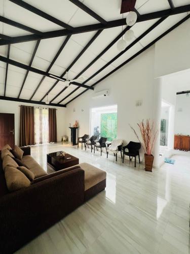 a living room with a couch and a table at White House in Ranala
