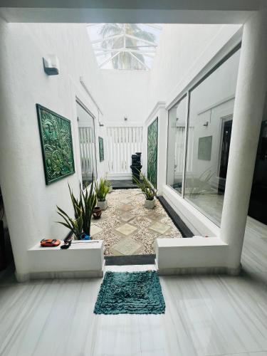 a living room with a room with a ceiling at White House in Ranala
