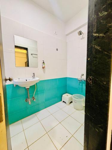 a bathroom with a sink and a toilet at The Royal Samrat Newly renovated in Pune