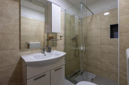 a bathroom with a sink and a shower at Apartments Sidro in Savudrija