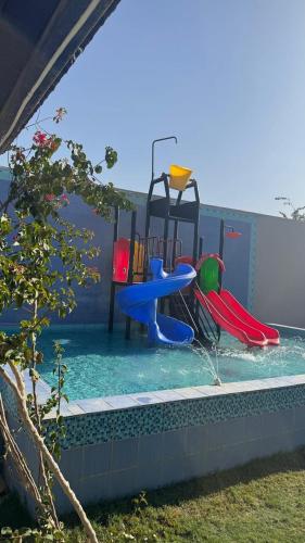 a pool of water with a playground in it at شاليهات وقت الفرح in Riyadh
