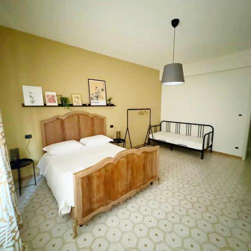 a bedroom with a large bed and a bench at TERRA DI SUD Matera - Free secure parking in Matera