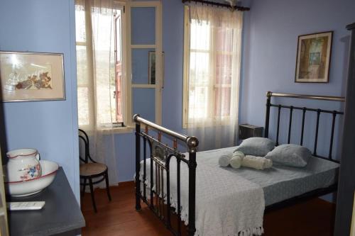 a bedroom with a bed in a room with blue walls at Traditional Villa Marina in Chios