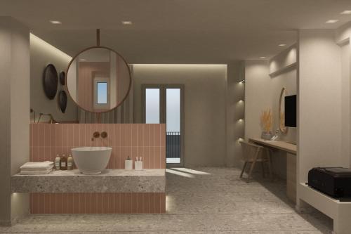 a bathroom with a sink and a mirror at Aktaion Signature Suites in Skala