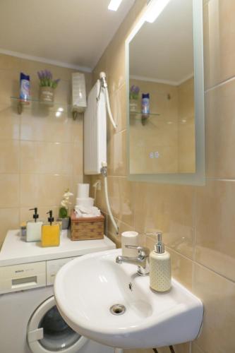 a bathroom with a sink and a mirror at BALLET MAISON in the heart of the city in Alexandroupoli