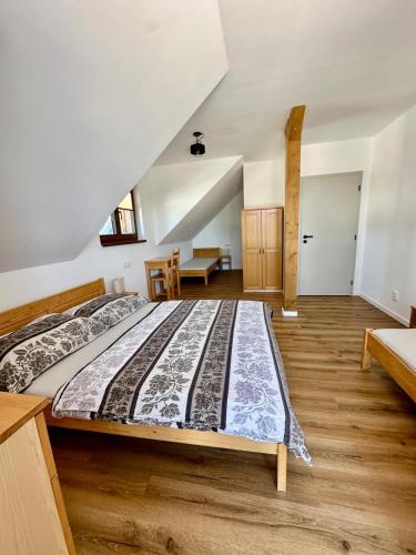 a bedroom with a large bed in a room at Pod Lovčí skálou in Modrava