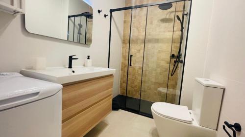 a bathroom with a shower and a sink and a toilet at Sunset Dream Suite El Cotillo in El Cotillo