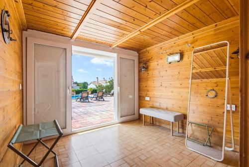 a room with a sliding glass door and a bench at Villa Varadero by Escape Home in Alaior
