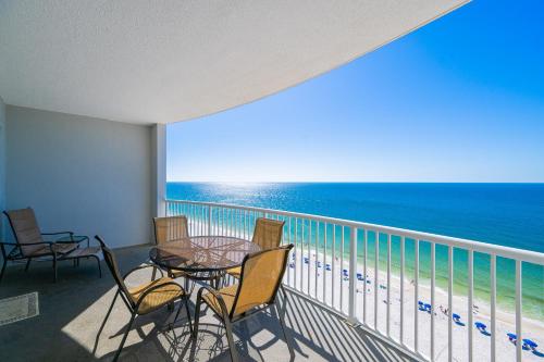 a balcony with a table and chairs and the ocean at Island Royale 404 in Gulf Shores