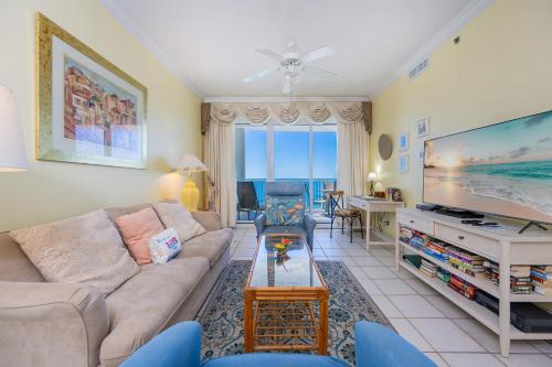 a living room with a couch and a flat screen tv at Island Royale 404 in Gulf Shores