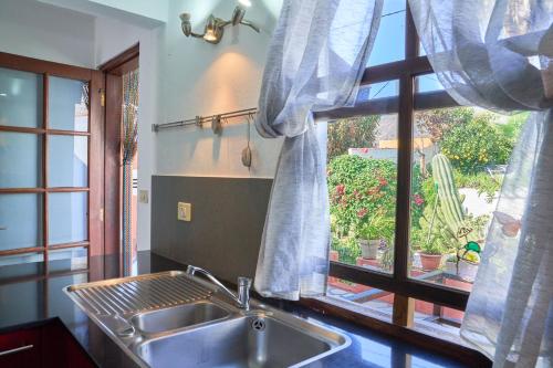 a kitchen with a sink and a window at Villa Sila in El Paso