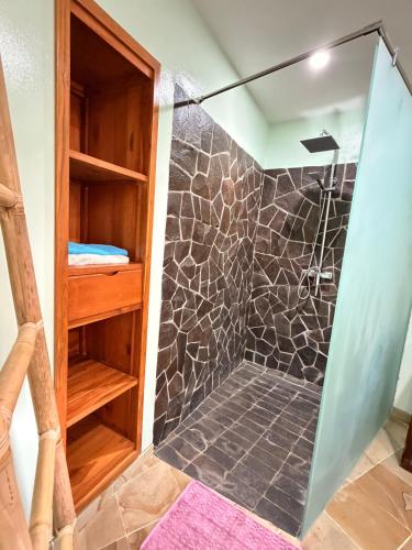 a bathroom with a shower with a glass door at Villa Ponjok Batu Residence in Bukti