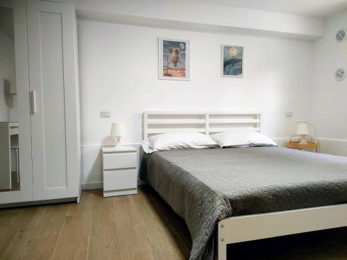 a bedroom with a bed and two pictures on the wall at Villa Toti in Montepaone