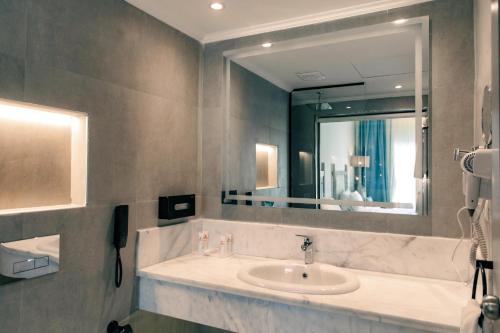 a bathroom with a sink and a large mirror at Sunny Days El Palacio Resort & Spa in Hurghada