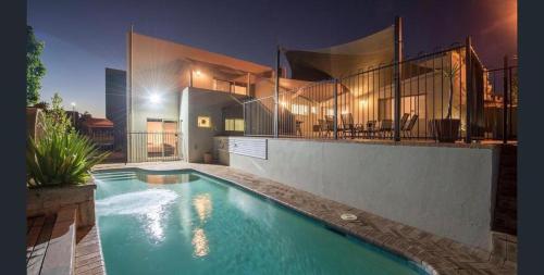a swimming pool in front of a house at night at The Studio on Barberry with a Pool in Perth