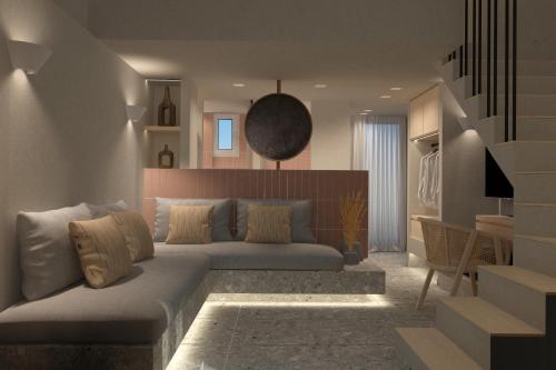 a living room with a couch and a staircase at Aktaion Signature Suites in Skala