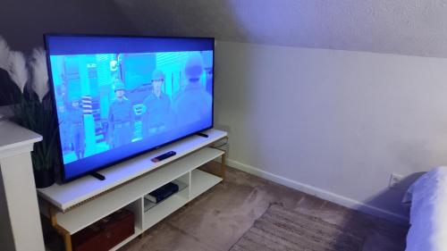 a flat screen tv sitting on a stand in a room at Kings Bay Private Room Shared Bathroom D in Decatur
